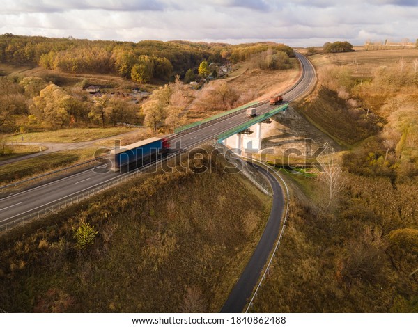White Truck with Cargo Semi\
Trailer Moving on Highway Road intersection junction. Aerial Top\
View