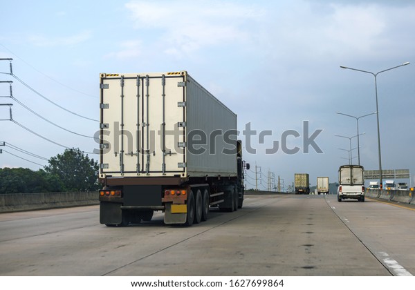 White Truck driving\
on highway road with  container, transportation\
concept.,import,export logistic industrial Transporting Land\
transport on the asphalt\
expressway