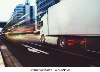 White Truck Moving Fast On The Road In A Modern City With Light Effect