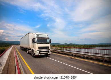  White Truck On A Bridge In Summer. 