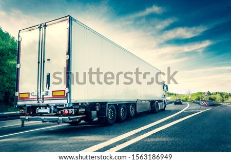 White truck on german highway with slight motion blur
