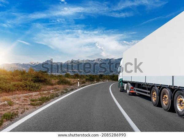 White\
truck on the highway. White truck on asphalt\
road.