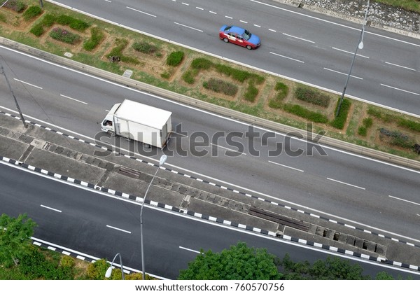 White\
truck on the highway interchange road captured in aerial top view\
for transportation or products shipping\
delivery