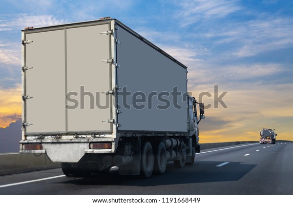 White Truck on\
highway road with  container, transportation concept.,import,export\
logistic industrial Transporting Land transport on the asphalt\
expressway 