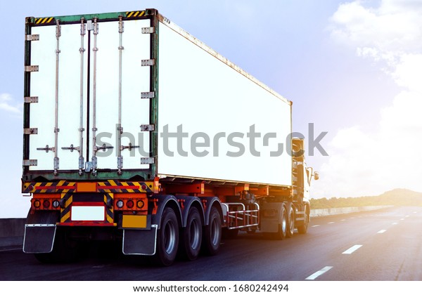 White\
Truck on highway road with  container, transportation\
concept.,import,export logistic industrial Transporting Land\
transport on the asphalt expressway againt blue\
sky