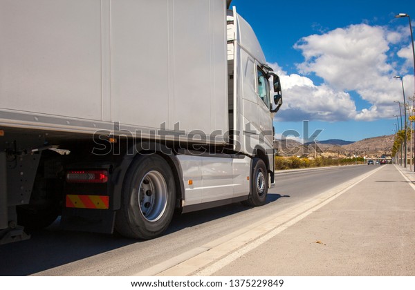 White truck on the road. Top view of the road.\
Shipping Place for text. Freight transport. Highway. Perspective.\
Motorway. Mock up.