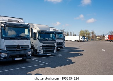 White Trucks On Parking Lot In Good Weather. Transport Company Vehicles Waiting At A Truck Stop.