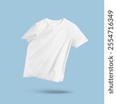 White t-shirt in air on light blue background