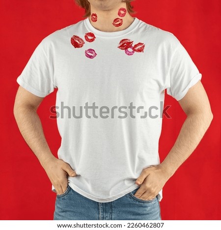 White t-shirt for mock-up print design. A young man wears a short-sleeved t-shirt, jeans, studio shot on a red background. Guy in white clothes for advertising.