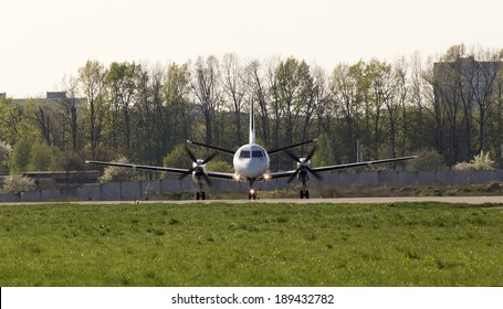 White Twin-engine Turboprop Short-haul Regional Airliner On The Runway, Front View