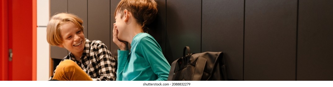 White Two Boys Laughing And Talking In Checkroom At School