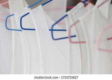 White undershirts on hangers for selective focus.Cleaning to prevent diseases that may affect illness.