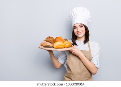 White uniform high hat industry manufacture people eating nutrition concept. Portrait of charming woman carrying wooden round tray full of yummy palatable nourishing bread isolated on gray background - Powered by Shutterstock