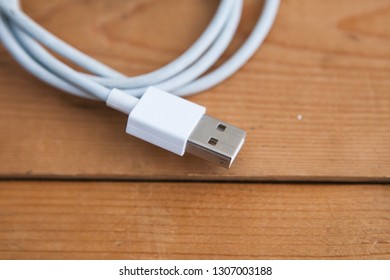 White USB Cable (USB Chord) On A Wooden Ground, Close Up