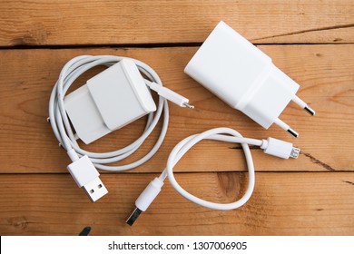 White USB Cable (USB Chord) On A Wooden Ground, Flat Lay (top View)