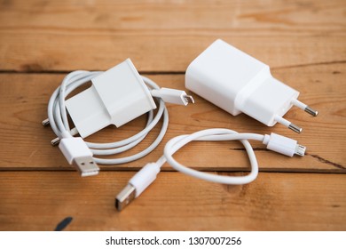 White USB Cable (USB Chord) On A Wooden Ground
