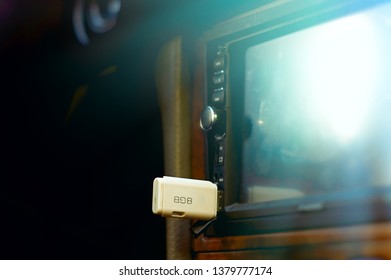 The white USB drive inserted into automobile player