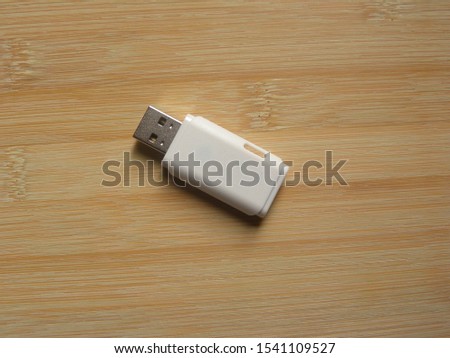 White USB flash pen drive kept on wooden table
