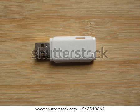 White USB flash pen drive on wooden table
