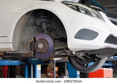  White Use Car Is Repair Disc Break Front Wheel In Garage Vehicle Service Shop                                      