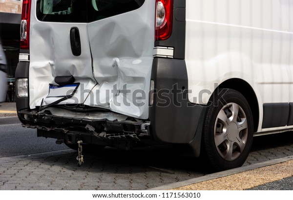 White van damaged\
after a rear-end collision when the other driver was not paying\
attention and did not\
brake