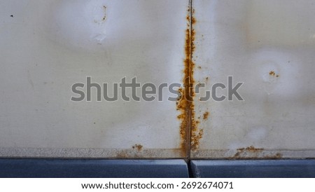 White van in poor condition shows rust, dents. The aged vehicle sits in a sunlit parking lot, conveying neglect, fatigue, and industrial grit. Car in need of repairs