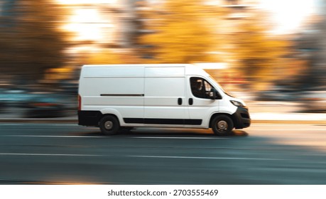 A white van is shown speeding down a road during the day with motion blur.