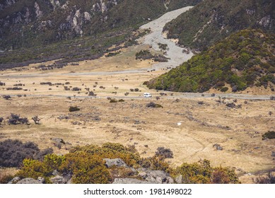 White Van Travelling Across Wide Open Landscape