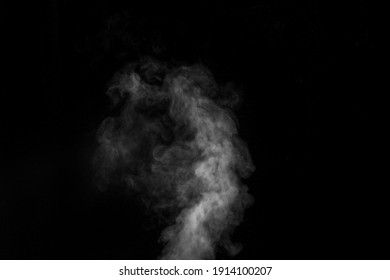 White Vapour Spray Steam From Air Saturator. Smoke Fragments On A Black Background. Abstract Background, Design Element, For Overlay On Pictures