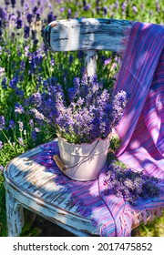 White Vase With Lavender Bouquet On Vintage Chair