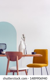 White Vase On Wooden Table With Fancy Dining Room Interior With White And Blue Wall