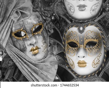 
white Venetian masks with golden designs