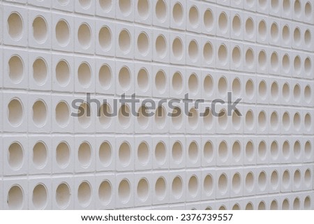 White ventilation block wall background with circle pattern in modern loft style, perspective side view