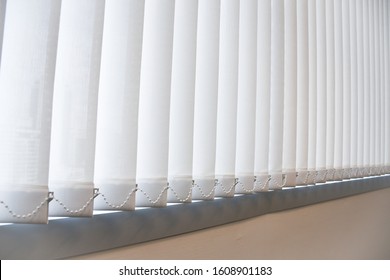 White vertical blind, Modern office sun blinds, Concept image for sustainable design and energy saving.