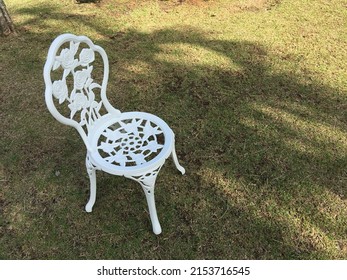 A White Victorian Chair In A Garden