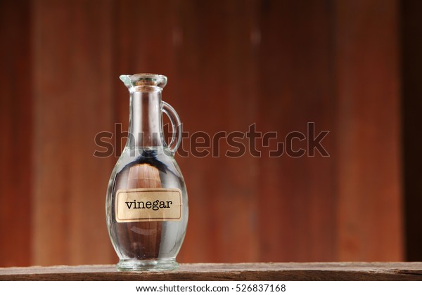 white vinegar on wooden\
background