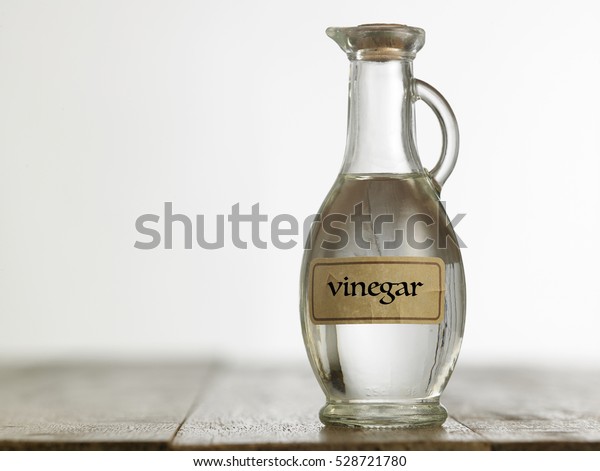 white vinegar on the\
wooden table top