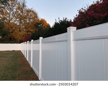 White vinyl fence in autumn