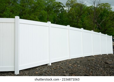 White vinyl fence fencing of private property grass plastic - Shutterstock ID 2156871063