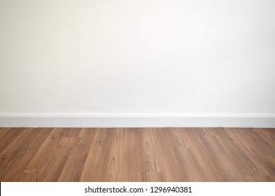 White Wall And Brown Wood Floor