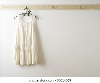 White Wall And Clothes On A Hanger.