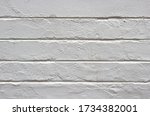 white wall with horizontal carved lines in the surface - blank background with relief