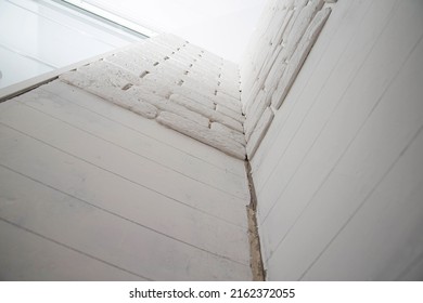 White Wall Made Of Decorative Stone In The Form Of A Brick. Laying Gypsum Bricks During Apartment Renovation.