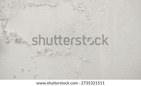 White wall paint background grumbling because it's been too long.Close up background of a white concrete cement wall that is cracked and the paint is peeling off. Old wall background wall with peeling