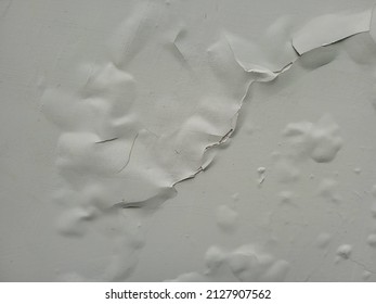 The White Wall Paint Is Bubbling And Cracked Due To The Humid Air