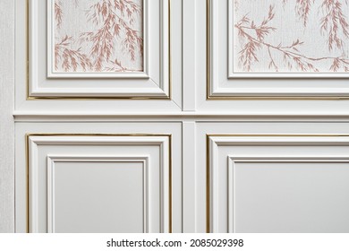 White Wall Panel With Gold Molding In Classic Style With Wallpaper With Floral Pattern In Light Spacious Room Of Cottage Closeup