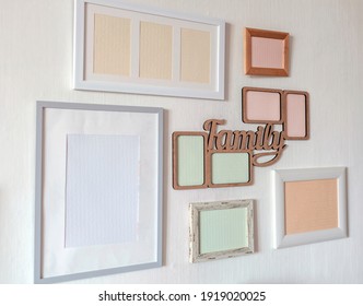 White Wall With Set Of Different Empty Vertical And Horizontal Picture Frames To Create Family Photo Gallery On The Wall, To Capture A Moment, Mockup Template On The White Background, Lifestyle