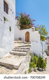 White wall and stone staircase. Typical greek town architecture - Shutterstock ID 700708249