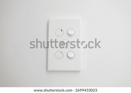 White wall switch panel with round buttons