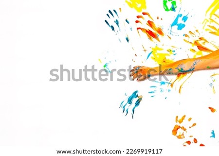 White wall with vivid multicolored hand prints. Concept equality
